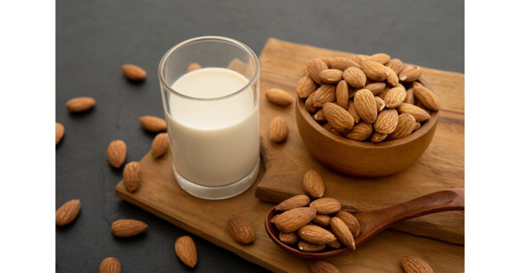 almond milk with almond wooden spoon bowl wooden