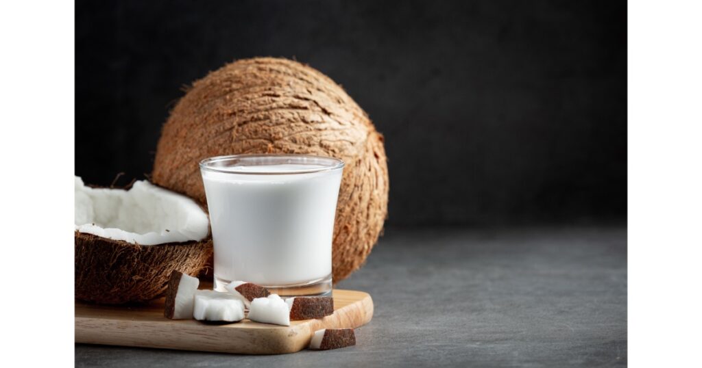 glass coconut milk put wooden cutting board